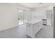 Open kitchen with quartz island, white cabinets, and stainless-steel appliances at 2367 Tilden Way, Henderson, NV 89074