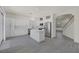 Bright open kitchen with white cabinets, stainless steel appliances, island, and view into the living room at 2367 Tilden Way, Henderson, NV 89074