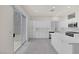 Bright kitchen features white cabinets, stainless steel appliances, a center island and sliding glass door at 2367 Tilden Way, Henderson, NV 89074