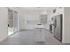Bright kitchen features white cabinets, stainless steel appliances, a center island and sliding glass door to backyard at 2367 Tilden Way, Henderson, NV 89074
