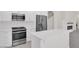 Kitchen island featuring white cabinets, stone countertop, and stainless steel appliances at 2367 Tilden Way, Henderson, NV 89074