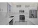 Bright kitchen features white cabinets, stainless steel appliances, and stone countertops at 2367 Tilden Way, Henderson, NV 89074