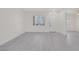 Spacious living room with grey wood-look flooring and a bright window view at 2367 Tilden Way, Henderson, NV 89074
