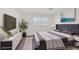 Staged bedroom with luxurious queen bed and modern furniture at 2367 Tilden Way, Henderson, NV 89074