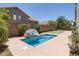 This backyard features a pool with rock decor, mature landscaping, and putting green at 2367 Tilden Way, Henderson, NV 89074