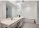 Bathroom featuring a dual vanity, large mirror, recessed lighting and a separate soaking tub at 2555 Hampton Rd # 2108, Henderson, NV 89052