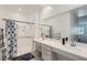Bright bathroom with a dual vanity, walk-in shower with curtain and tiled floors at 2555 Hampton Rd # 2108, Henderson, NV 89052