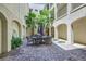 Community courtyard featuring outdoor seating and lush tropical landscaping at 2555 Hampton Rd # 2108, Henderson, NV 89052