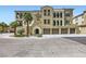 Charming condo building featuring Spanish-style architecture, palm trees, and private garages at 2555 Hampton Rd # 2108, Henderson, NV 89052