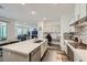 Bright, open kitchen with large island, stainless steel appliances, and view of living area at 2555 Hampton Rd # 2108, Henderson, NV 89052