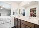 Bathroom featuring double sinks, modern fixtures, with bedroom and closet views at 285 Rain Quail Way, Henderson, NV 89012