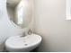 Cozy half bathroom featuring a modern round mirror and sink at 285 Rain Quail Way, Henderson, NV 89012