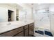 Bathroom featuring double sinks, modern fixtures, and glass shower door at 285 Rain Quail Way, Henderson, NV 89012