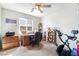 Bedroom with wooden desk, shelving and an exercise bike at 285 Rain Quail Way, Henderson, NV 89012