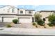 Charming townhome features a neutral color palette, brick driveway and a two-car garage at 285 Rain Quail Way, Henderson, NV 89012