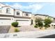 Stunning townhome exterior with a large driveway, and desert landscaping at 285 Rain Quail Way, Henderson, NV 89012