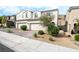 Beautiful two-story townhome with desert landscaping and a brick driveway at 285 Rain Quail Way, Henderson, NV 89012