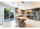This kitchen features stainless steel appliances, dining area and sliding door access to the backyard at 285 Rain Quail Way, Henderson, NV 89012