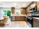 This kitchen features stainless steel appliances, tile backsplash and backyard view at 285 Rain Quail Way, Henderson, NV 89012