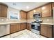 This kitchen features stainless steel appliances, tile backsplash and quartz countertops at 285 Rain Quail Way, Henderson, NV 89012