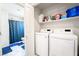 Convenient laundry area with washer, dryer, and storage shelves at 285 Rain Quail Way, Henderson, NV 89012