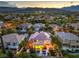 An aerial view shows a property with a pool, landscaped yard, and outdoor lighting in a peaceful neighborhood at 2982 Hammerwood Dr, Las Vegas, NV 89135
