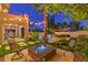 Charming backyard featuring a fire pit, pool, and beautiful landscaping with string lights at 2982 Hammerwood Dr, Las Vegas, NV 89135