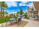 Outdoor dining and entertaining with a pristine pool, lush landscaping and clear skies at 2982 Hammerwood Dr, Las Vegas, NV 89135