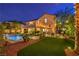 This backyard features a pool, patio, and artificial turf, creating a perfect blend of relaxation and recreation at 2982 Hammerwood Dr, Las Vegas, NV 89135