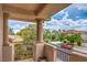 Balcony with views of a landscaped neighborhood, houses, and mature trees at 2982 Hammerwood Dr, Las Vegas, NV 89135