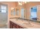 Bright bathroom featuring double sinks, ample counter space, and a separate bathtub and shower at 2982 Hammerwood Dr, Las Vegas, NV 89135