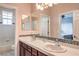 Bathroom featuring double sinks, tile backsplash, and a view into an adjacent bedroom at 2982 Hammerwood Dr, Las Vegas, NV 89135