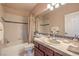 Bright bathroom featuring a shower-tub combination, vanity with sink, tile, and traditional fixtures at 2982 Hammerwood Dr, Las Vegas, NV 89135