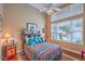 Bedroom with a colorful bedspread, high ceilings, large windows and hardwood floors at 2982 Hammerwood Dr, Las Vegas, NV 89135