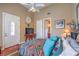 Comfortable bedroom featuring a colorful bedspread, cozy pillows, and a rustic wooden nightstand at 2982 Hammerwood Dr, Las Vegas, NV 89135