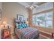 Comfortable bedroom with a ceiling fan, window, and unique Southwestern-style decor at 2982 Hammerwood Dr, Las Vegas, NV 89135