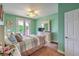 Cozy bedroom featuring pastel walls, ceiling fan, and access to an outdoor balcony at 2982 Hammerwood Dr, Las Vegas, NV 89135