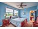 Blue bedroom with dual pane windows, ceiling fan and cherry wood furniture at 2982 Hammerwood Dr, Las Vegas, NV 89135