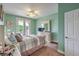 Cozy bedroom with balcony access, light green walls, and a decorative white dresser at 2982 Hammerwood Dr, Las Vegas, NV 89135