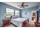Bedroom with a queen-size bed, wood furniture, and large windows providing natural light at 2982 Hammerwood Dr, Las Vegas, NV 89135