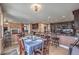 An open-concept dining area shows the table, chairs, and the kitchen and living room in a single frame at 2982 Hammerwood Dr, Las Vegas, NV 89135