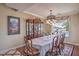 Inviting dining area featuring a stylish chandelier, elegant decor, and views of the backyard pool at 2982 Hammerwood Dr, Las Vegas, NV 89135