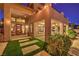 Back of home showcasing covered patio, manicured lawn, and lush landscaping; ideal for entertaining at 2982 Hammerwood Dr, Las Vegas, NV 89135