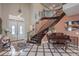 Bright foyer with high ceilings, decorative staircase, double entry doors, and beautiful tile flooring at 2982 Hammerwood Dr, Las Vegas, NV 89135