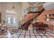 Grand foyer featuring high ceilings, decorative wrought iron staircase, and elegant tile flooring at 2982 Hammerwood Dr, Las Vegas, NV 89135