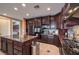 Well-equipped kitchen with granite countertops, stainless steel appliances, and dark wood cabinets at 2982 Hammerwood Dr, Las Vegas, NV 89135