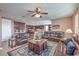 Open-concept living area with leather sofas, a ceiling fan, and easy access to the kitchen at 2982 Hammerwood Dr, Las Vegas, NV 89135
