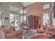 Cozy living room featuring tall ceilings, a large window to the backyard, and comfortable seating at 2982 Hammerwood Dr, Las Vegas, NV 89135