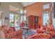 Cozy living room with high ceilings, large windows, and stylish furnishings leading to backyard at 2982 Hammerwood Dr, Las Vegas, NV 89135