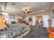 A spacious main bedroom featuring a ceiling fan, sitting area, and connecting door to another room at 2982 Hammerwood Dr, Las Vegas, NV 89135